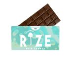 A Rize 12G Mushroom Chocolate Bar peeks from its light blue-green Rize packaging labeled Milk Crunch, with a mushroom graphic and MEGADOSE 12G at the top, suggesting a unique psychedelic experience.