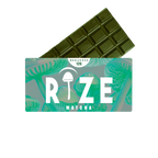 A green Rize 12G Mushroom Chocolate Bar is partially wrapped in packaging labeled RIZE, featuring psychedelic mushroom illustrations on a turquoise background.