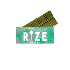 A green Rize 5G Mushroom Chocolate Bar, partially unwrapped to show its leafy design and mushroom illustration, sits on a white background, hinting at a unique magic mushroom blend.